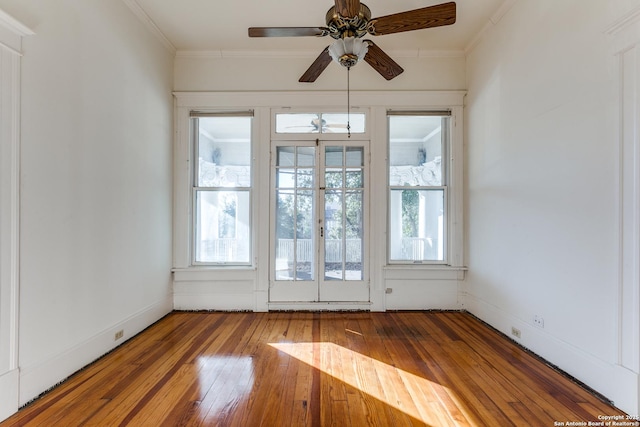 spare room featuring ceiling fan, wood-type flooring, and crown molding