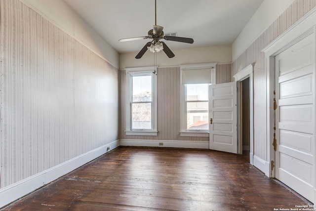 spare room with ceiling fan and dark hardwood / wood-style flooring