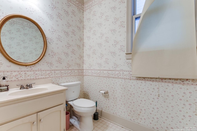 bathroom featuring toilet and vanity