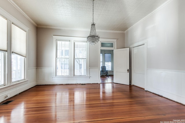 interior space featuring crown molding, dark wood-type flooring, and a notable chandelier