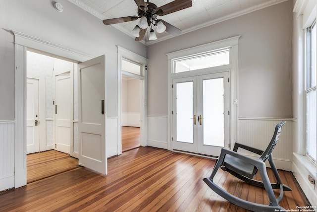 foyer featuring ceiling fan, dark hardwood / wood-style flooring, ornamental molding, and french doors