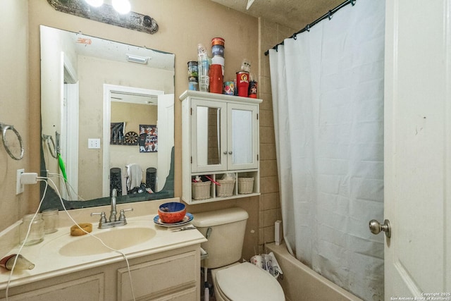 full bathroom with vanity, shower / bath combo with shower curtain, and toilet