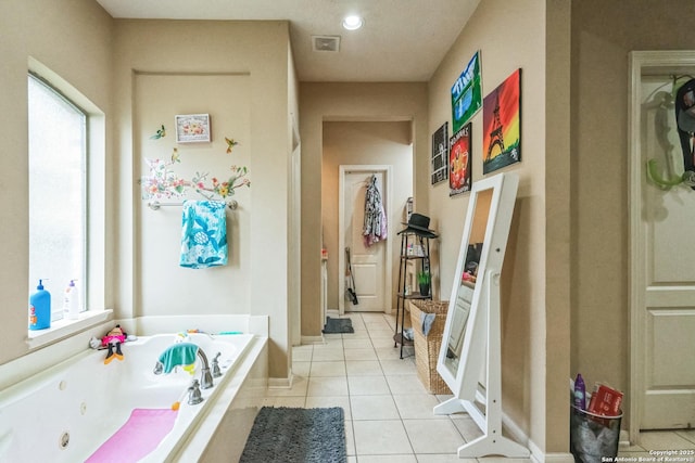 bathroom featuring a washtub and tile patterned floors