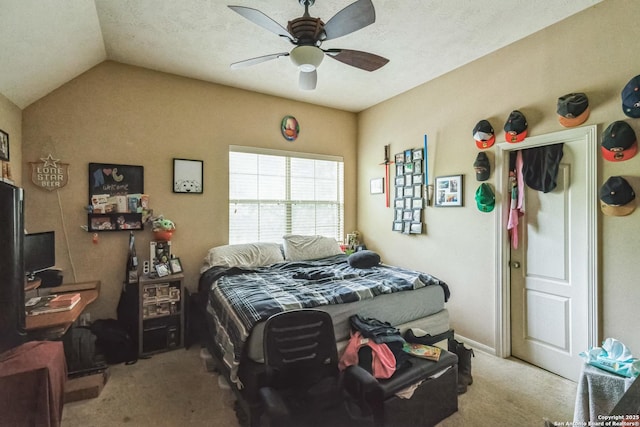 carpeted bedroom featuring lofted ceiling, a textured ceiling, and ceiling fan