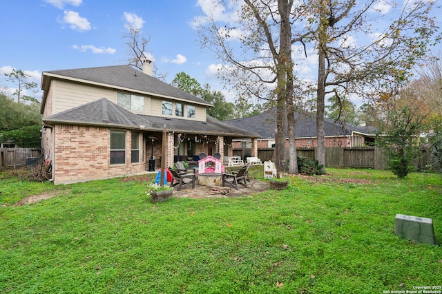 back of house featuring a patio and a lawn