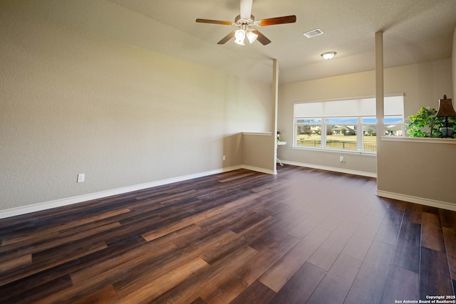 unfurnished room with ceiling fan and dark wood-type flooring