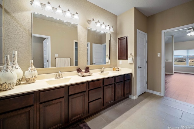 bathroom with tile patterned flooring, ceiling fan, and vanity