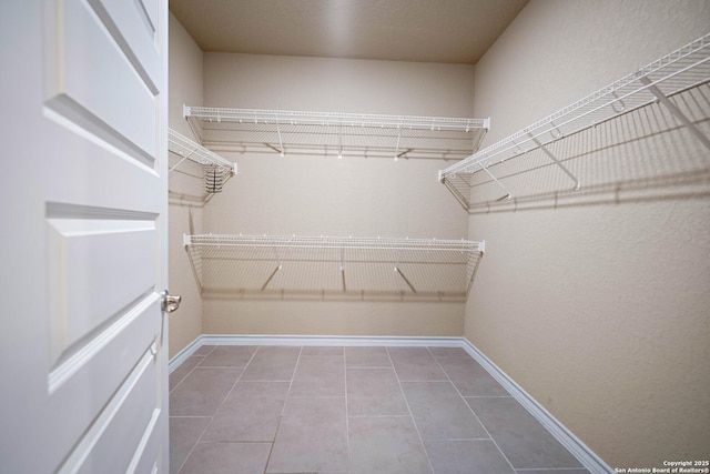 spacious closet featuring tile patterned flooring