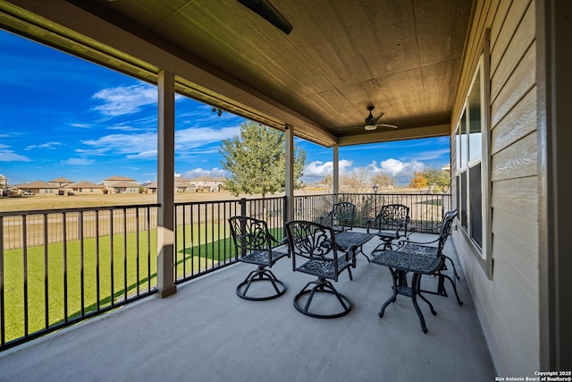 sunroom featuring ceiling fan and wooden ceiling