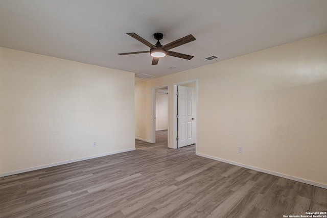 spare room featuring light wood-type flooring and ceiling fan