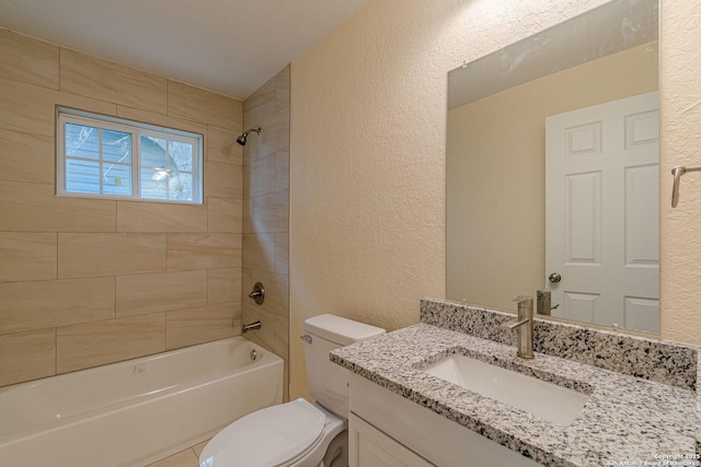 full bathroom featuring tile patterned floors, toilet, vanity, and tiled shower / bath combo