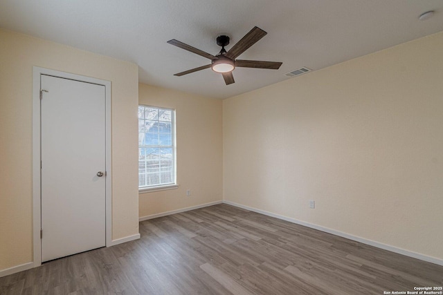 unfurnished room featuring light wood-type flooring and ceiling fan