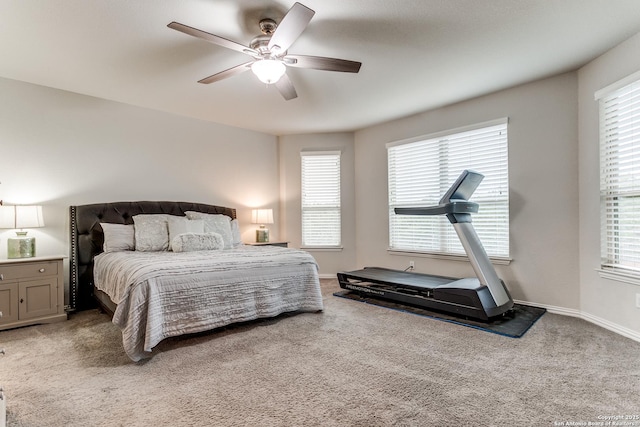 bedroom with ceiling fan, multiple windows, and carpet flooring