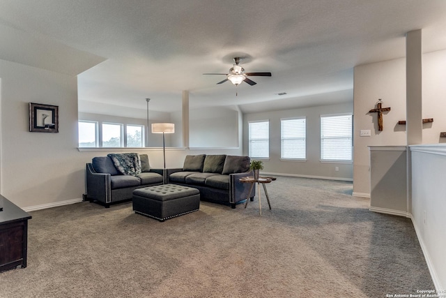 living room with ceiling fan and carpet