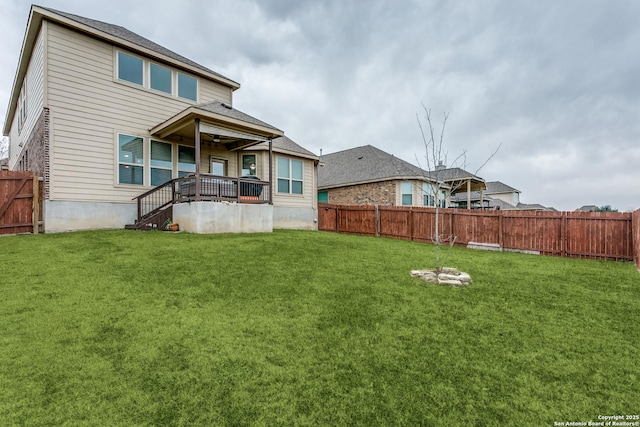 rear view of house with a yard