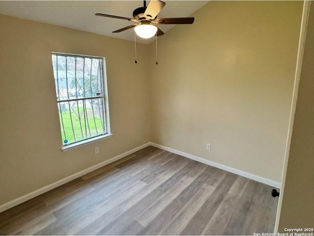 empty room with ceiling fan, a healthy amount of sunlight, and light hardwood / wood-style floors