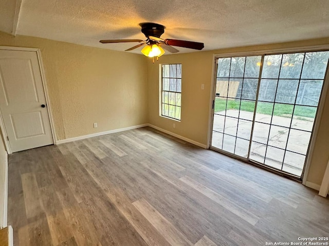 spare room featuring ceiling fan, a textured ceiling, and light hardwood / wood-style floors