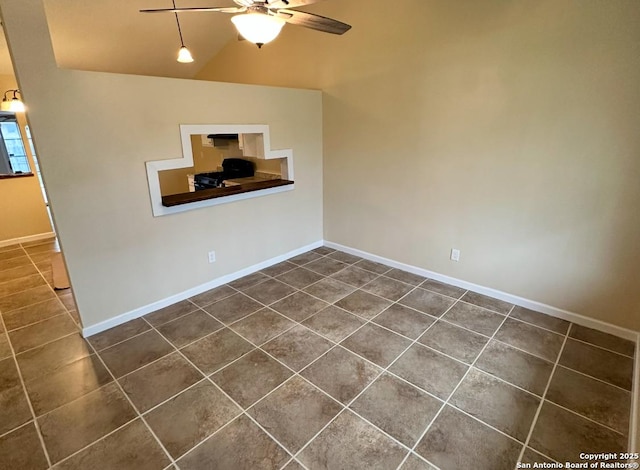 tiled spare room featuring lofted ceiling and ceiling fan