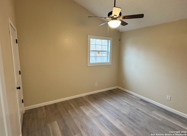 unfurnished room with hardwood / wood-style flooring, vaulted ceiling, and ceiling fan