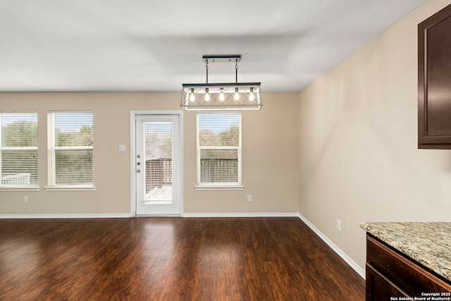 unfurnished dining area with dark hardwood / wood-style flooring