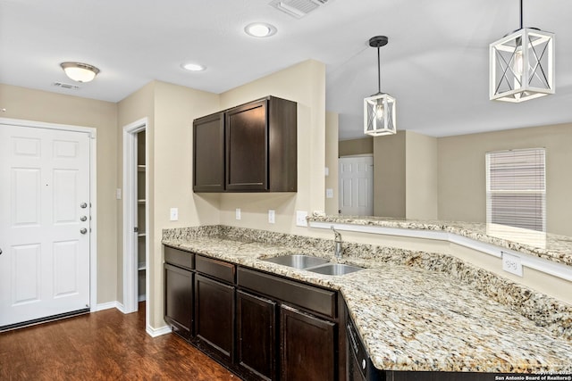 kitchen with sink, pendant lighting, kitchen peninsula, and dark hardwood / wood-style floors