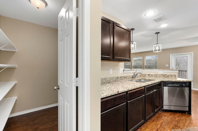 kitchen featuring decorative light fixtures, dark wood-type flooring, sink, light stone counters, and stainless steel dishwasher