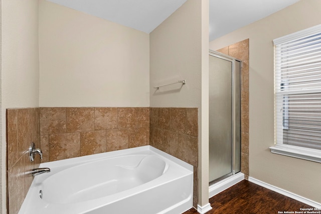 bathroom with wood-type flooring and separate shower and tub