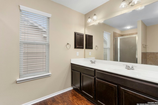 bathroom with vanity, an enclosed shower, and wood-type flooring