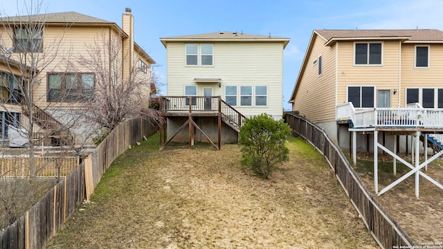 back of house with a wooden deck