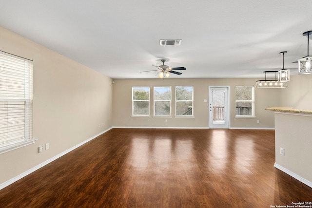 unfurnished living room with dark wood-type flooring and ceiling fan