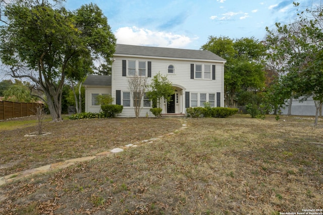 colonial home with a front lawn