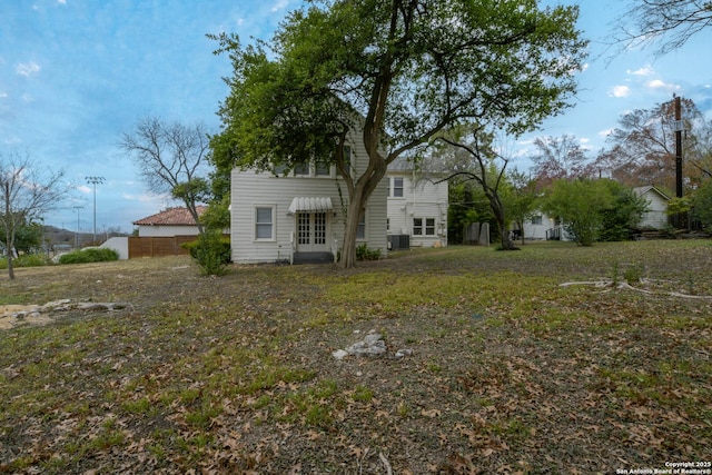 exterior space featuring central air condition unit and a yard