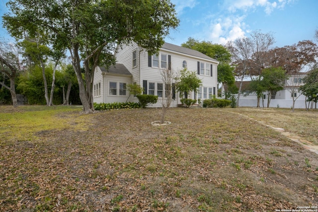 colonial house featuring a front lawn