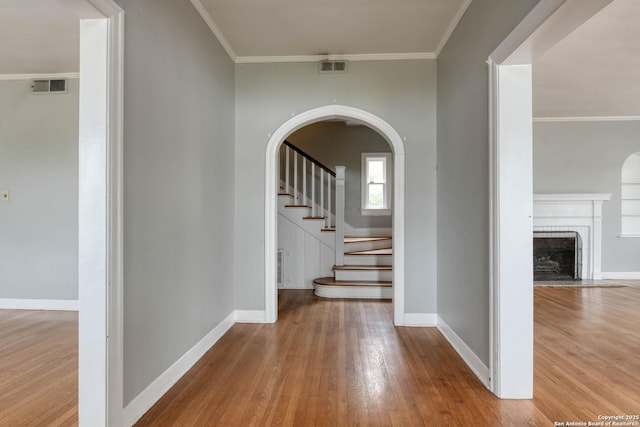 hall featuring ornamental molding and hardwood / wood-style floors