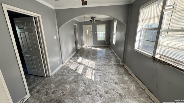 corridor featuring plenty of natural light and ornamental molding