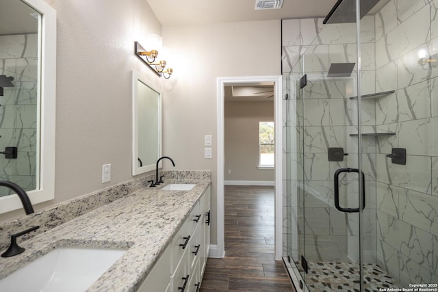 bathroom featuring vanity, a shower with shower door, and hardwood / wood-style flooring