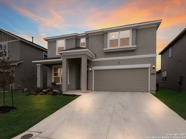 view of front of house with a garage and a lawn