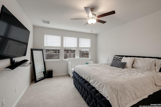 bedroom with ceiling fan and light colored carpet