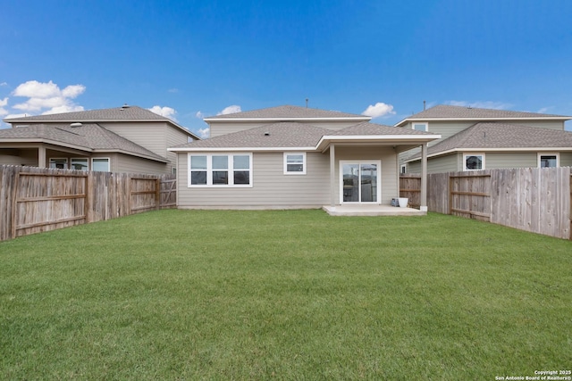 rear view of house featuring a patio area and a yard