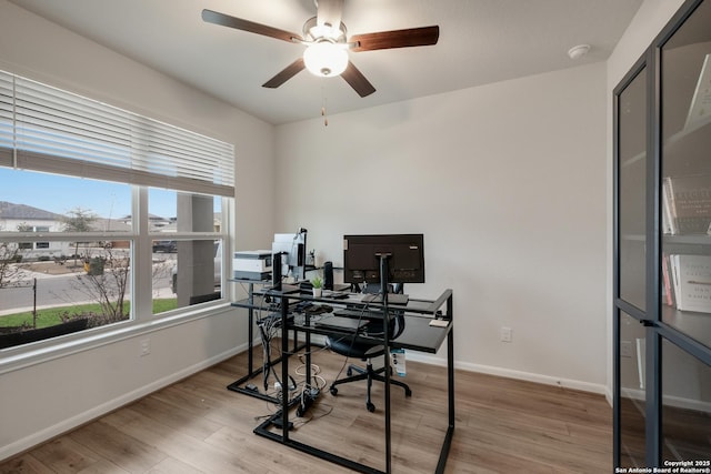 office space featuring light wood-type flooring and ceiling fan