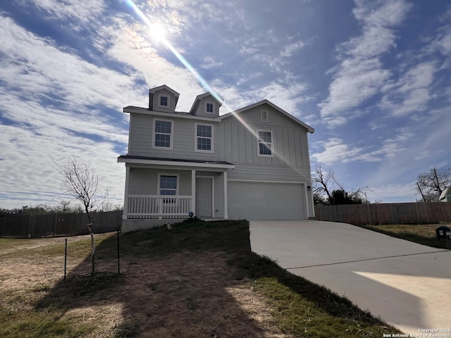 view of front facade with a garage and covered porch