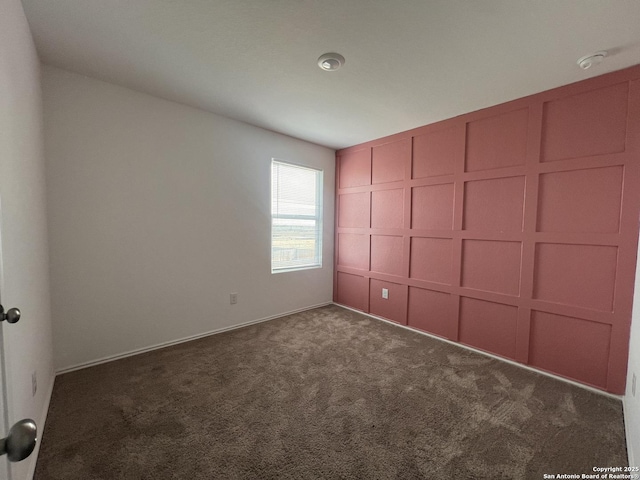 unfurnished bedroom with dark carpet