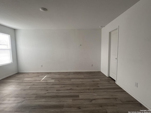 spare room featuring dark hardwood / wood-style floors