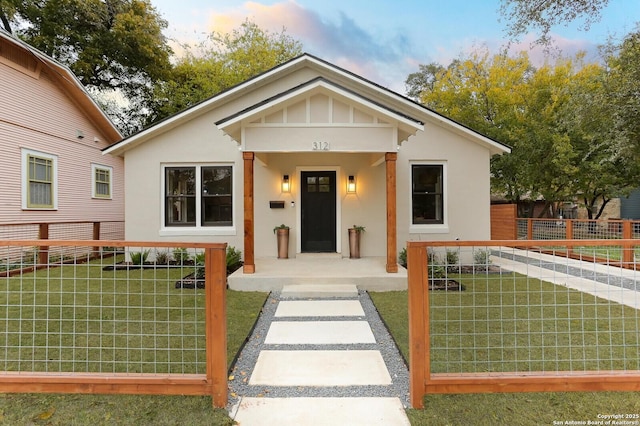 bungalow-style home featuring a yard