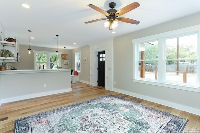 interior space with light hardwood / wood-style flooring and ceiling fan