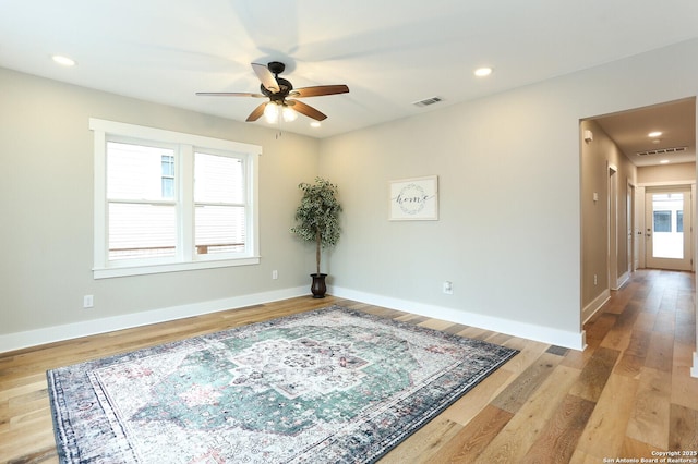 unfurnished room with ceiling fan and light hardwood / wood-style flooring