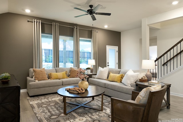 living room with ceiling fan and light hardwood / wood-style floors