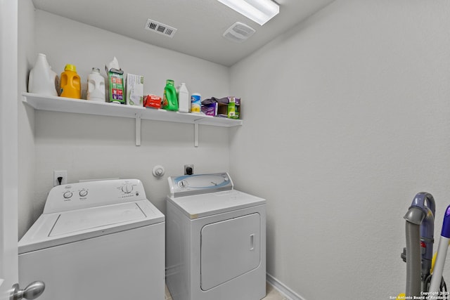 clothes washing area featuring independent washer and dryer