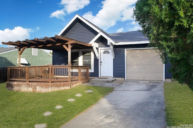 view of front facade featuring a garage, a front yard, and a wooden deck