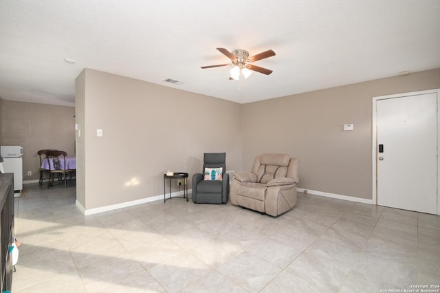 sitting room featuring ceiling fan